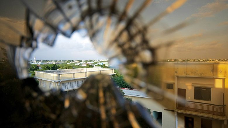 A view of the skyline beyond the northern suburbs of Mogadishu is seen through a bullet hole in the window of a hotel in the Yaaqshiid District of Mogadishu, where African Union Mission in Somalia (AMISOM) forces have pushed Al Shabaab militants beyond the city's northern fringes to the outskirts of the Somalia seaside.