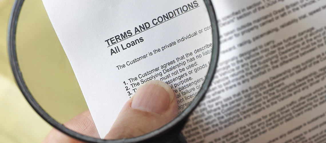 Holding magnifying glass to read the fine prints | © shutterstock.com