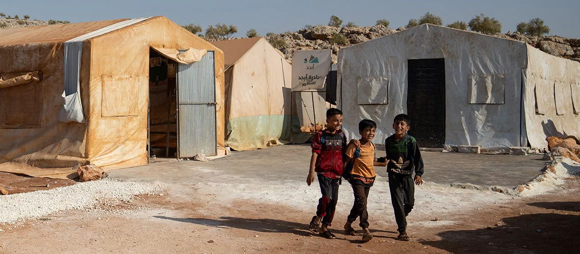 Children attend the first day of school in a refugees camp. | © shutterstock.com
