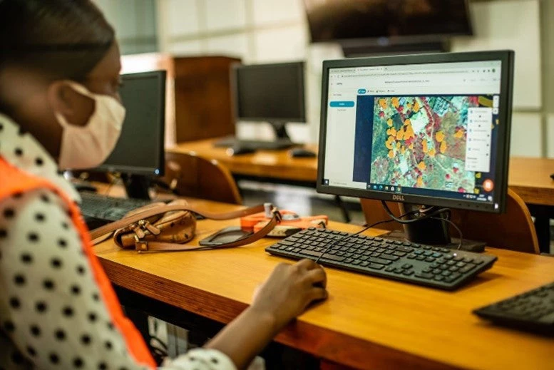 A young female Resilience Academy trainee builds a training dataset for tree canopy identification in Dar Es Salaam Tanzania