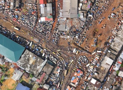 Aerial view of heavy traffic and crowding on the streets around the Duala Market