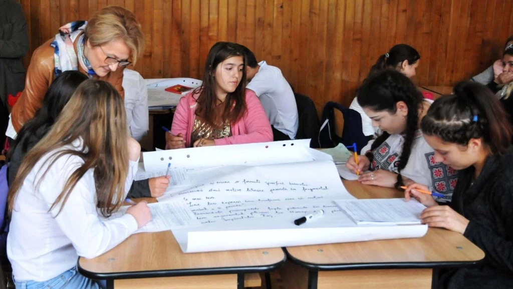 Schoolkids and their teacher in the classroom, Romania