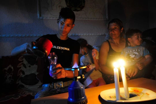 A Roma family in Macedonia prepares coffee during a black out