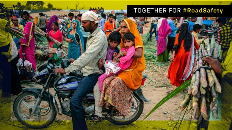 An Indian family on a motorcycle in a motley colored crowd at the sugar cane market in Pushkar. Photo Credit: Serhii Mykhalchuk / Shutterstock