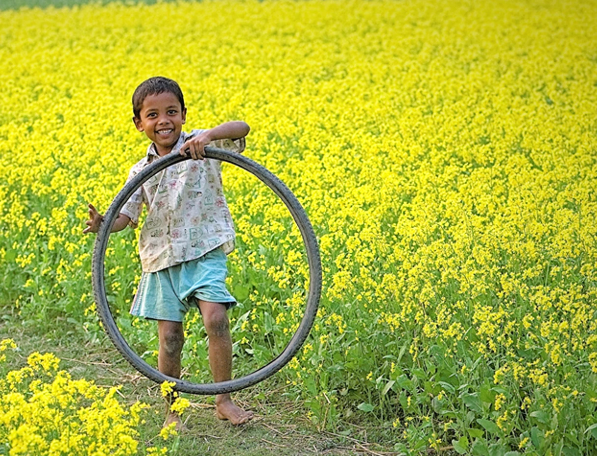 Bangladesh rural child in mustard field 