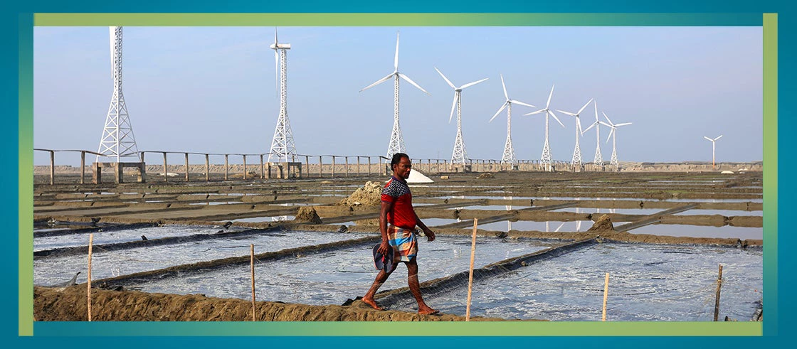 Picture of man at a wind power mill in Bangladesh 