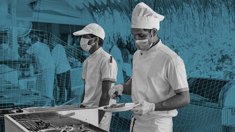 Chefs and hotel workers work at the buffet in protective face masks at a resort in Maldives.