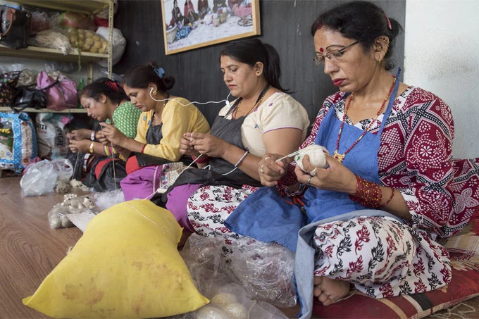 Women knit handicrafts for export at Everest Fashion Fair Craft in Lalitpur, Nepal