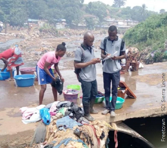 People washing clothes by the river