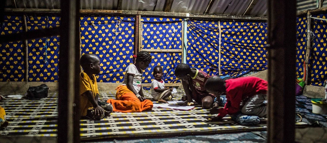 Children study inide the family house at night time, in Diadiam 3 village, region of Saint Louis, Senegal, thanks to the electricity that was installed. Photo: Vincent Tremeau/The World Bank