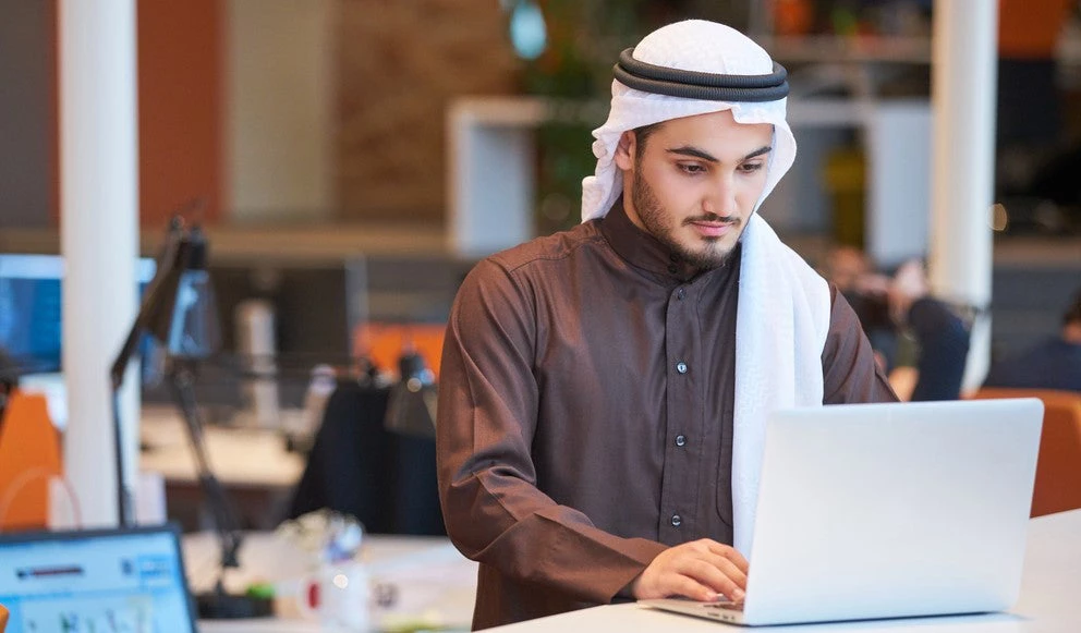 Young man working in an office.