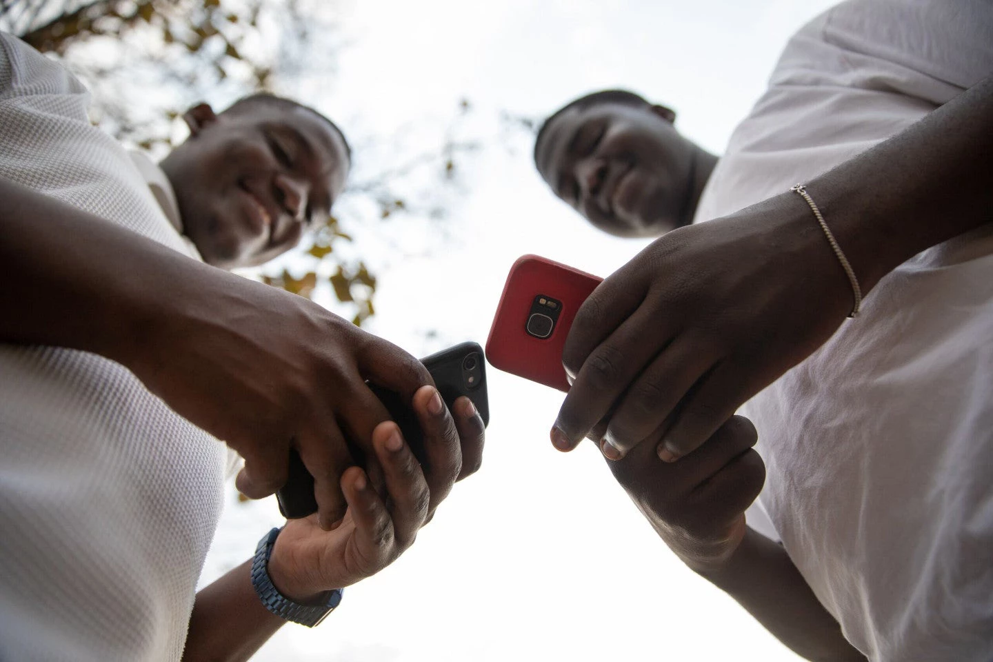 African men holding their mobile phones.