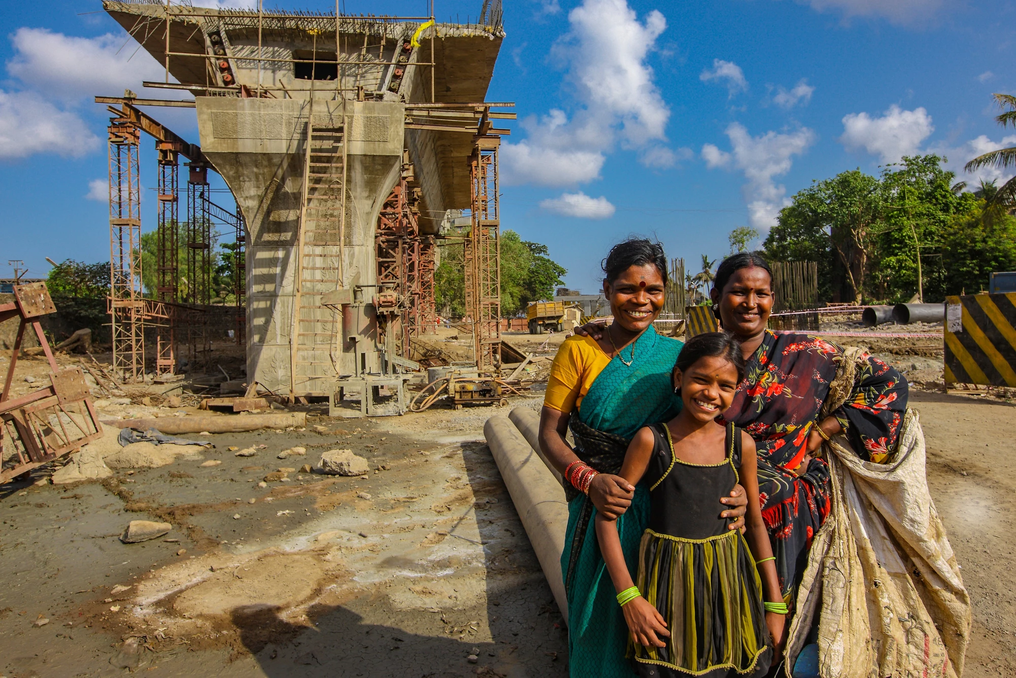 Mumbai ,Maharashtra ,May,30,2010:Rag picker happy family smiling for a portrait near santacruz Chembur Link Road bridge under construction ,Mumbai,Maharashtra,India