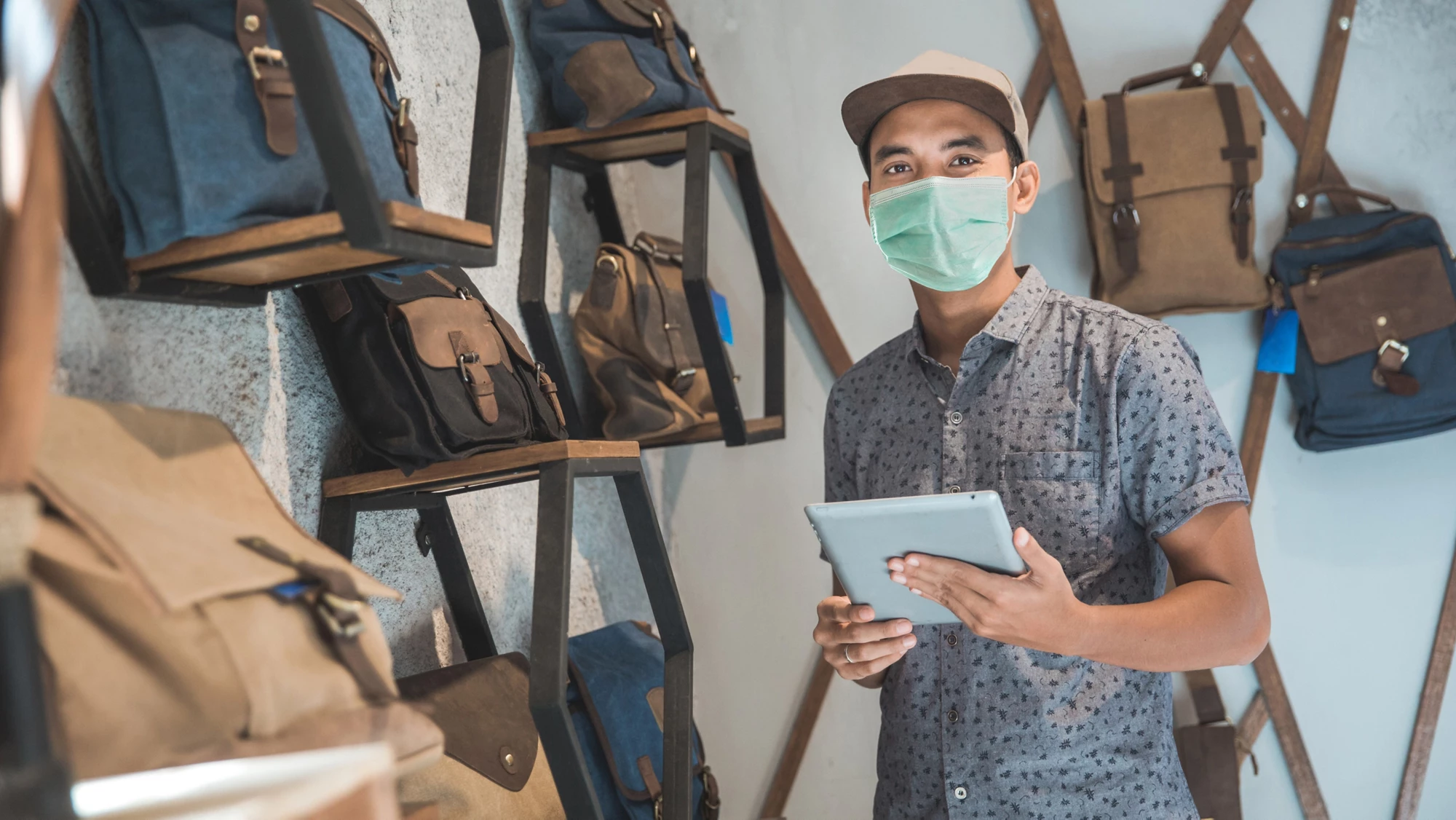 Indonesia male business owner keep working and wear face masks
