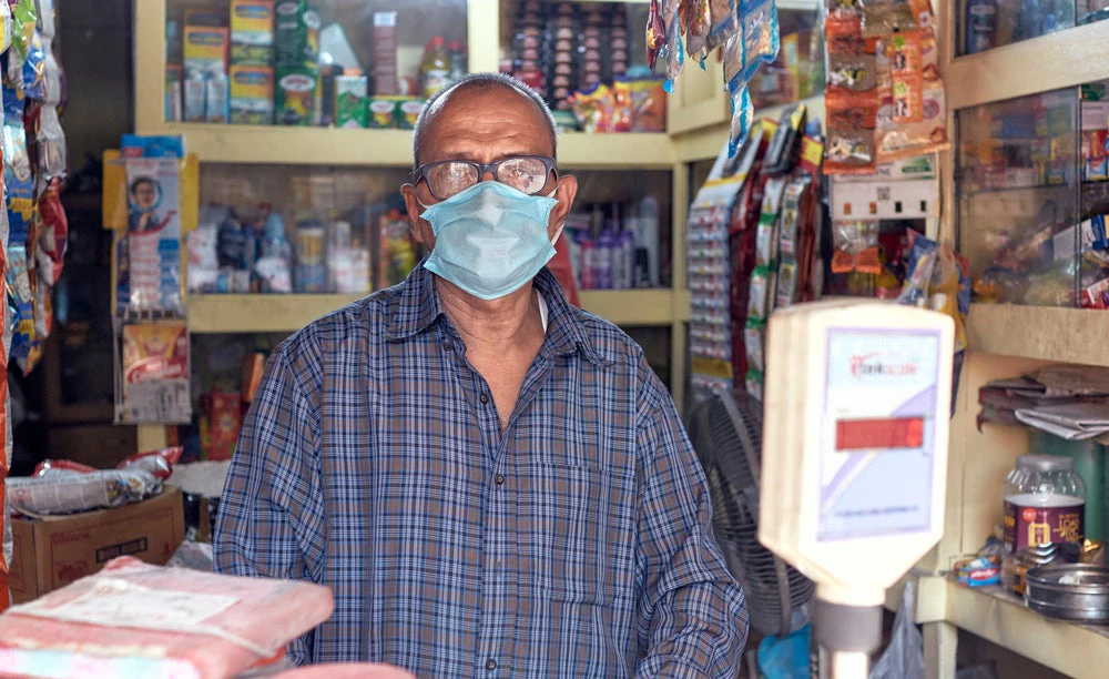 Kolkata, India, 03/22/2020: Awareness of common people during COVID-19 in outbreak in city. A grocery owner with protective face mask.  ©suprabhat/Shutterstock
