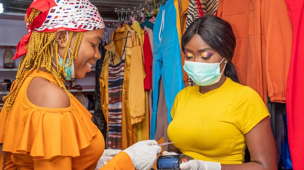 women in shop using contactless payment