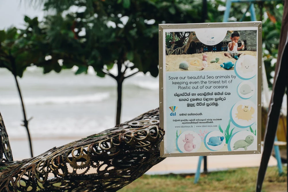 Weligama, Sri Lanka, July 2020: a sign to collect plastic on beach and plastic garbage collection reservoir. Photo: Surf Stories / Shutterstock.com 