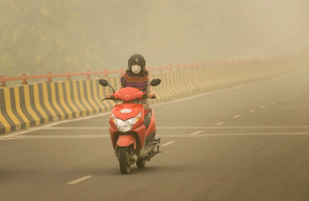 Ghaziabad, Uttar Pradesh/India- Woman with mask riding bike. Photo Credit: PradeepGaurs / Shutterstock.com 