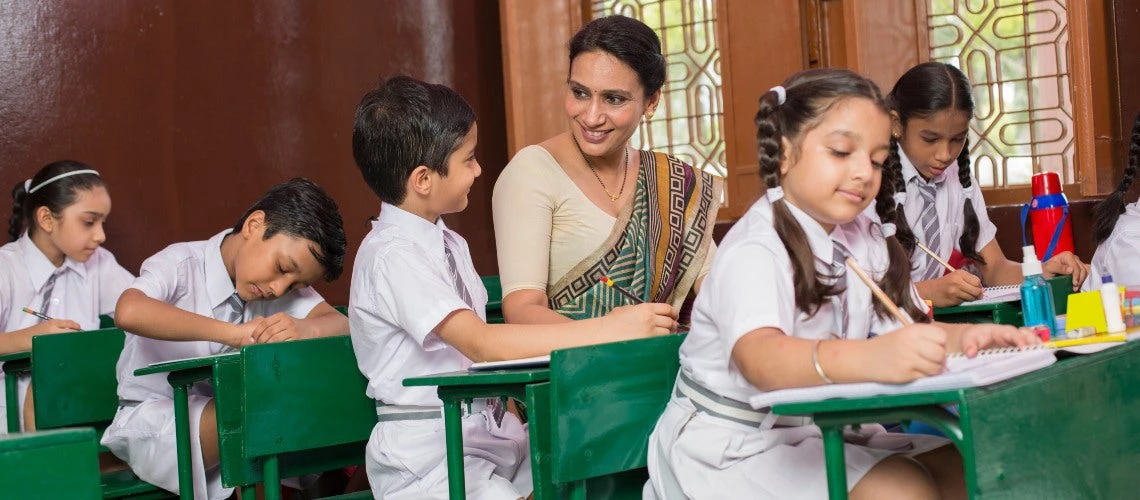 Teacher helping a schoolgirl