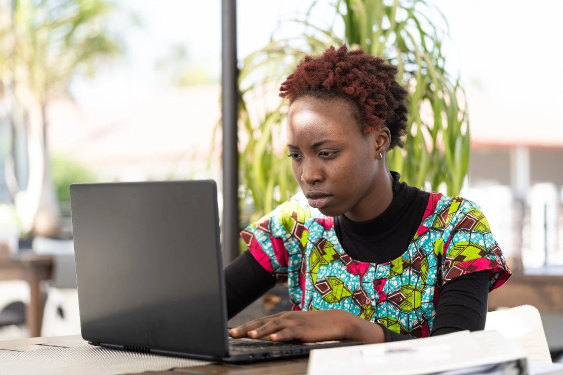 Woman sitting at her laptop and searching for a job on the internet