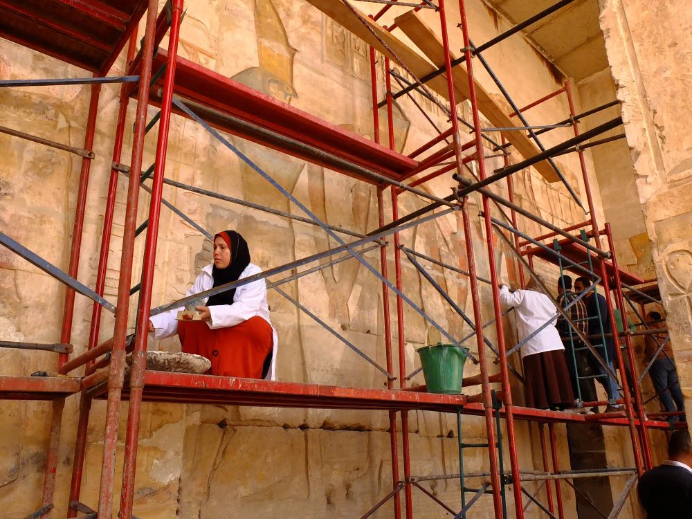 Woman works on restoration of Temple of Seti I in Sohag, Egypt- December 2021. (Shutterstock.com/Robert Szymanski)