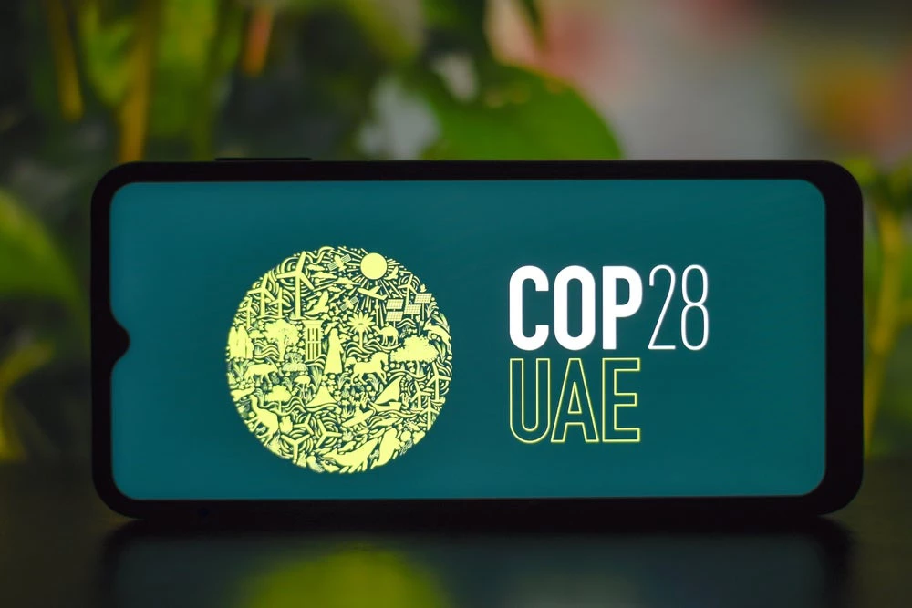 Photo of a cell phone with COP28 UAE on the screen. (Shutterstock.com)