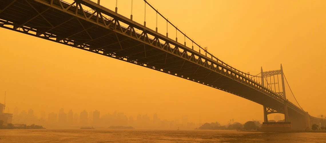 The Triborough Bridge along the East River in New York City with massive air pollution from Canadian wildfires.