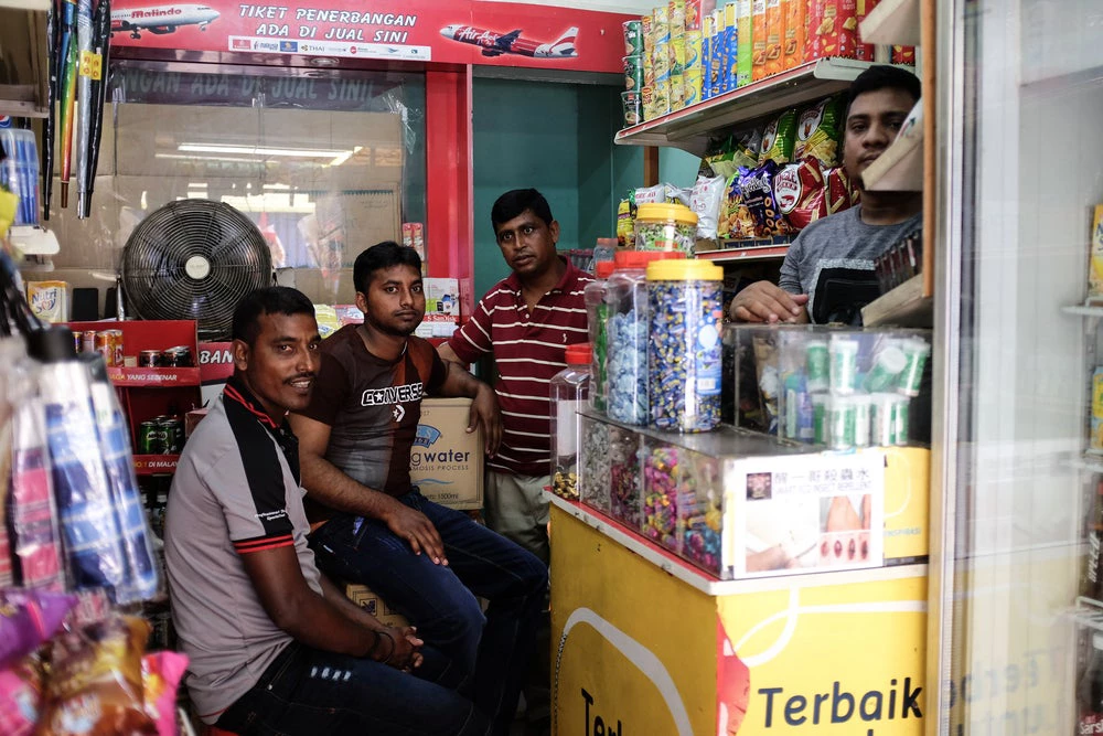Bangladeshi migrant workers operating a grocery store in Kuala Lumpur, Malaysia. Photo:Abd. Halim Hadi/Shutterstock.com
