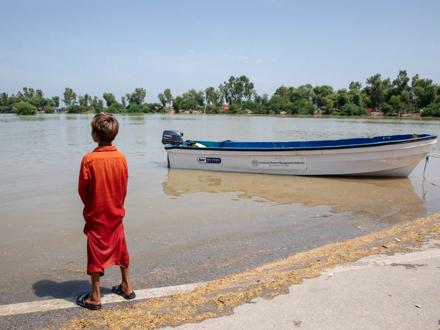 A boy in Sindh looks at the enormity of what it is now covered with flood waters