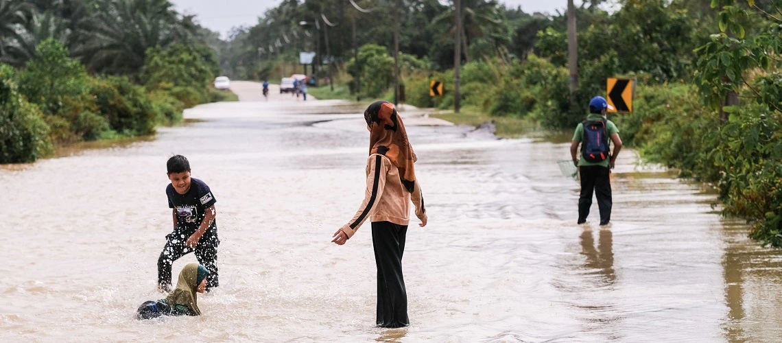 A group of kids playing in flood water. Pekan, Malaysia.