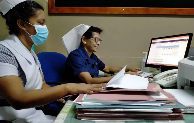 Healthcare workers in Sri Lanka enter data into the DHIS2 COVID-19 surveillance system