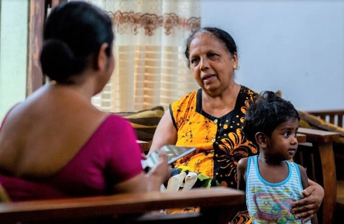 Women taking a survey w/child on her lap