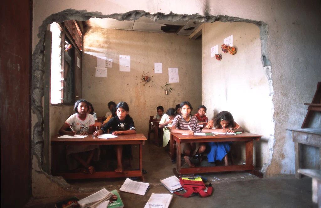 Students in a war-damaged classroom in Timor-Leste. © Alex Baluyut/World Bank