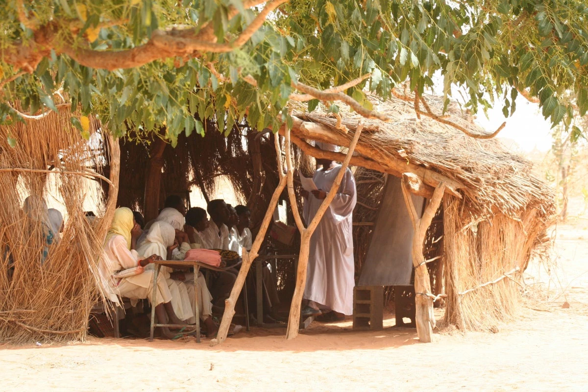 Students in Om Albadry, Sudan, take lessons in a makeshift shack, which will soon be replaced by a school building.