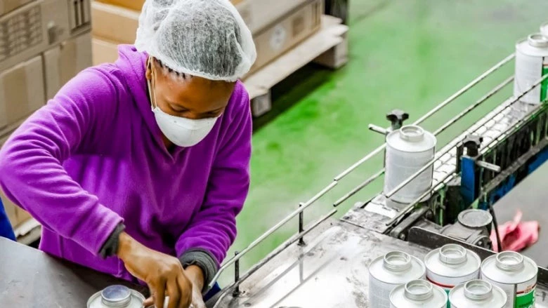 Woman working on an assembly line in a glue factory