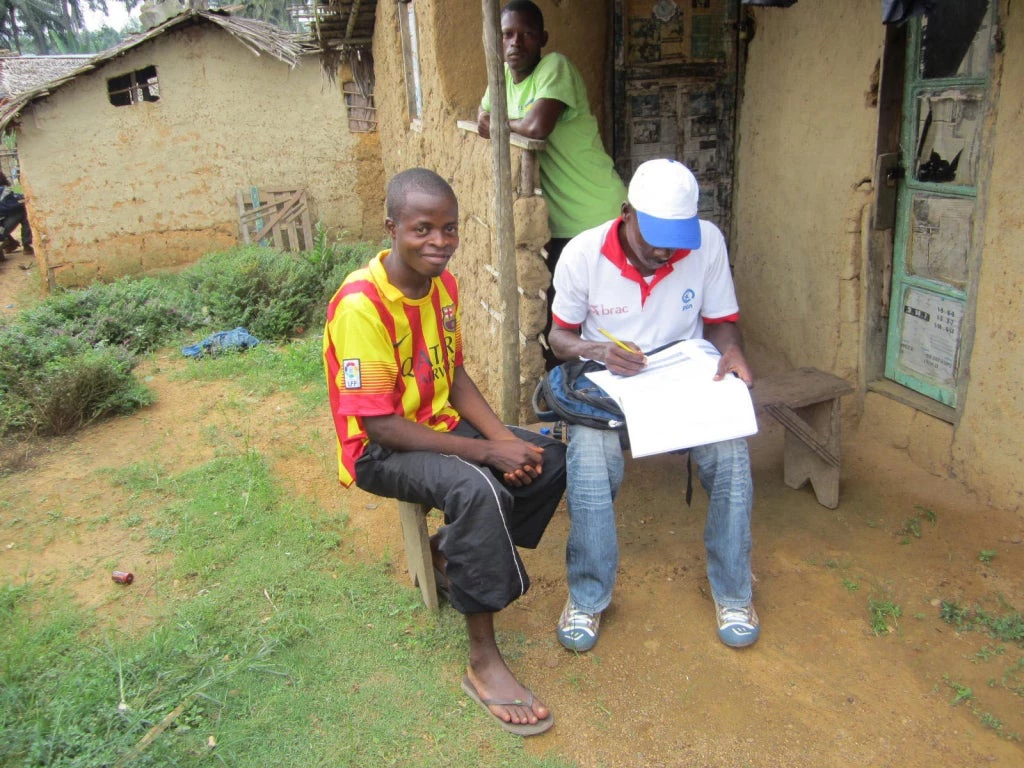 Field staff conducting interview with a household head in south eastern Liberia