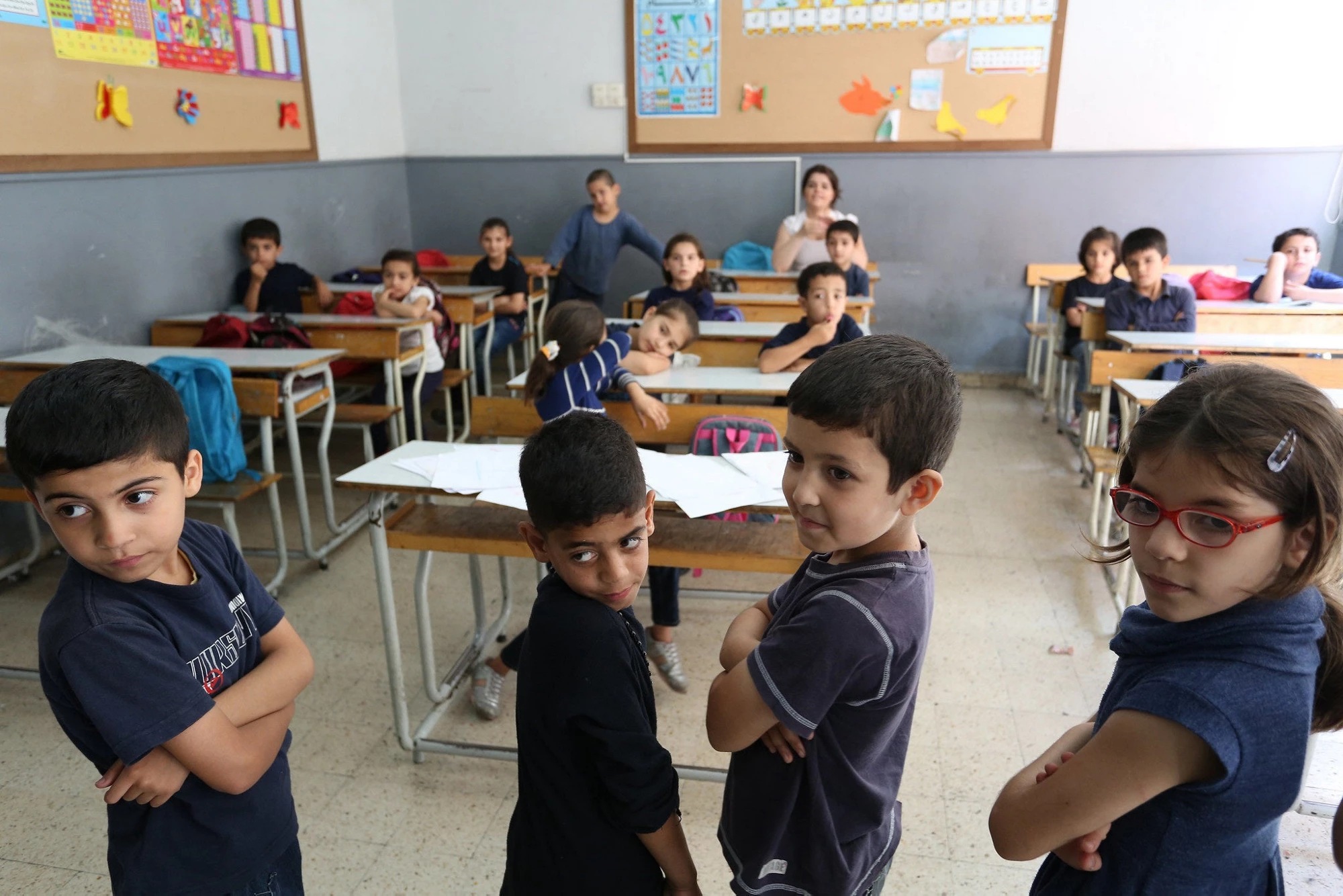 Syrian refugee students listen to their school teacher during math classes at a public school in Beirut, Lebanon