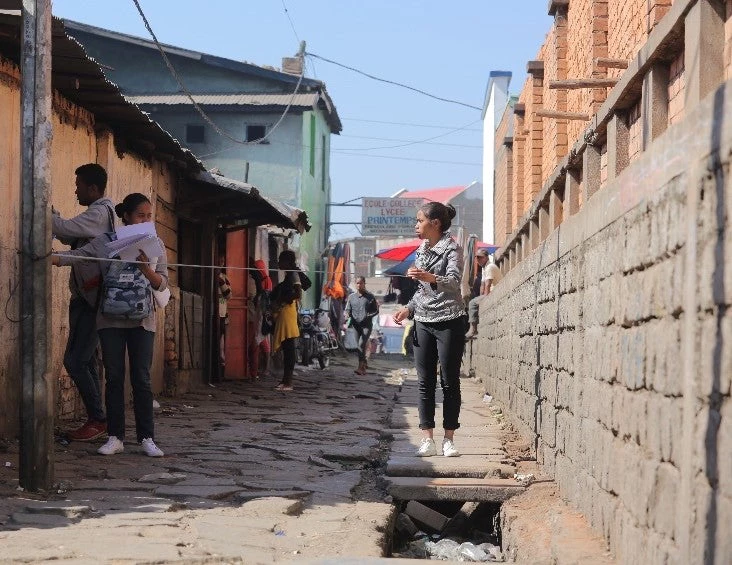 Members of the Open Cities Antananarivo team move through the project community in small teams.