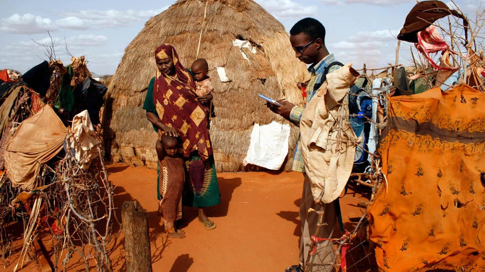An aid worker collects health and (mal)nutrition data during a field visit
