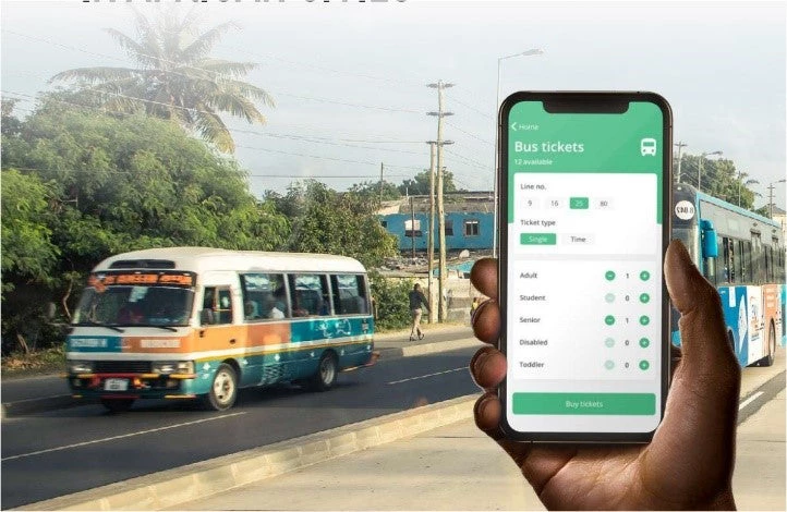 An African man holds a phone showing a bus schedule with different fare purchasing options