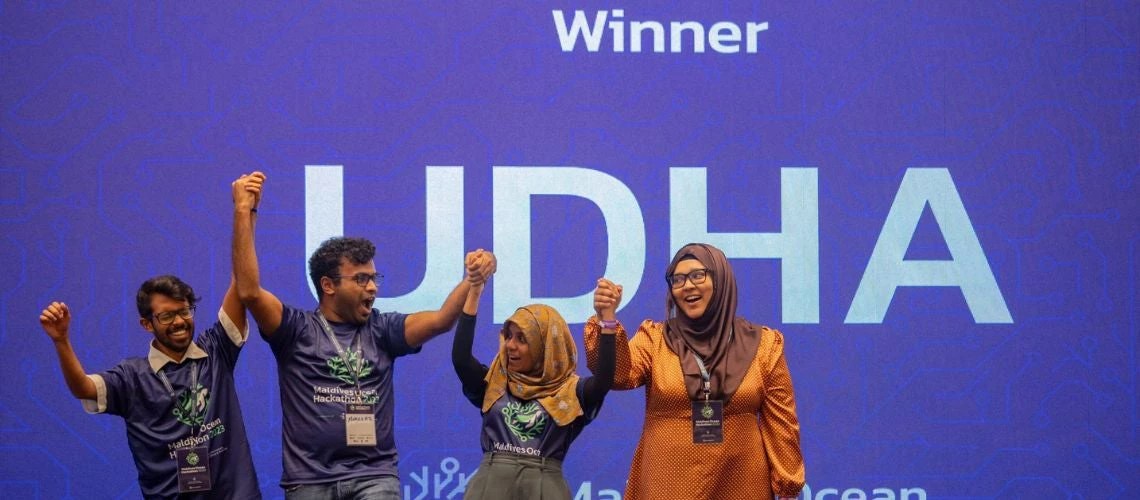 The winners of the 1st Maldives Ocean Hackathon 2023 smiling eagerly in front of the audience.