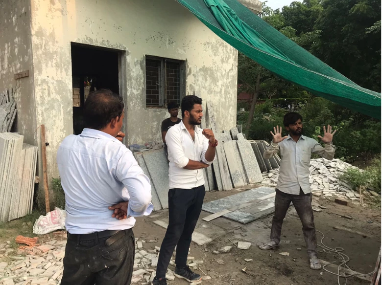 Ravinder Kumar (right), a mason in New Delhi. The green tarpaulin rigged up to provide some shade was his sole protection from the scorching temperatures earlier this year. Photo: IORA Ecological Solutions