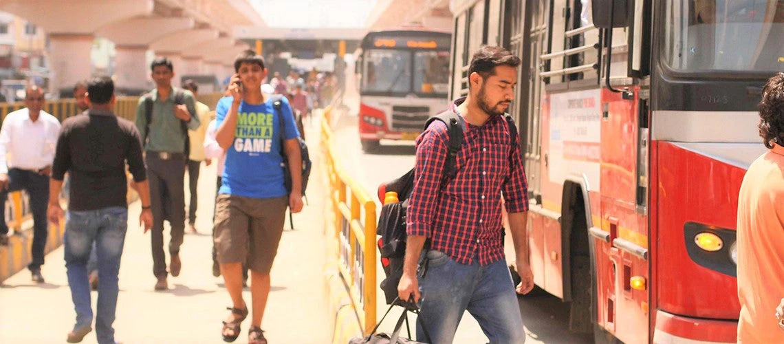 Commuters walk in and out of a Bus Rapid Transit station in Pune, India.