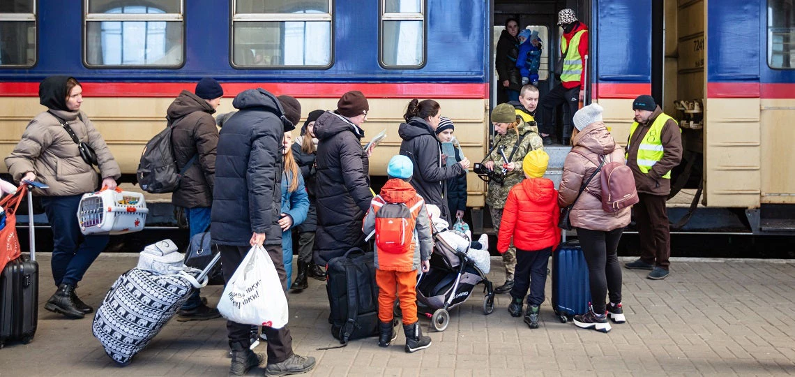 Ukrainian refugees on Lviv railway station waiting for train to escape to Europe