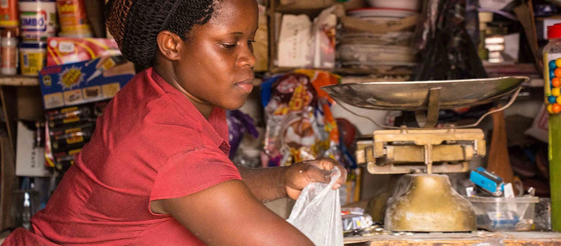 Sarah Nakagulire tends her shop in the neighborhood of Ttula, in Kampala, Uganda. Photo: Sarah Farhat/ The World Bank