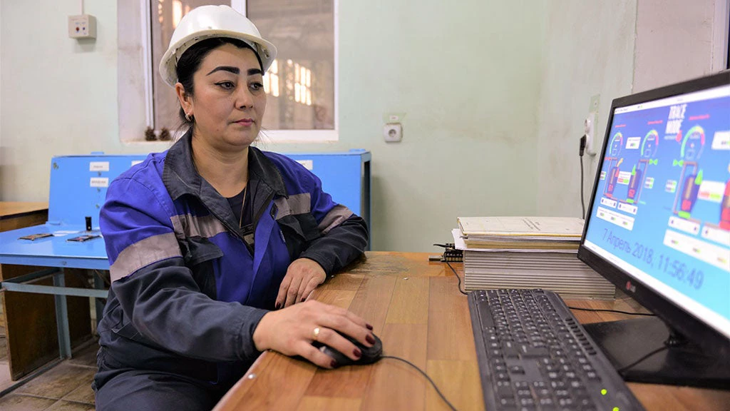 Woman operating a digital dashboard in Uzbekistan.