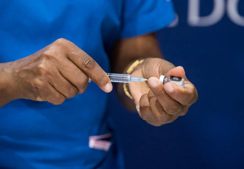 A man is preparing a COVID-19 vaccine