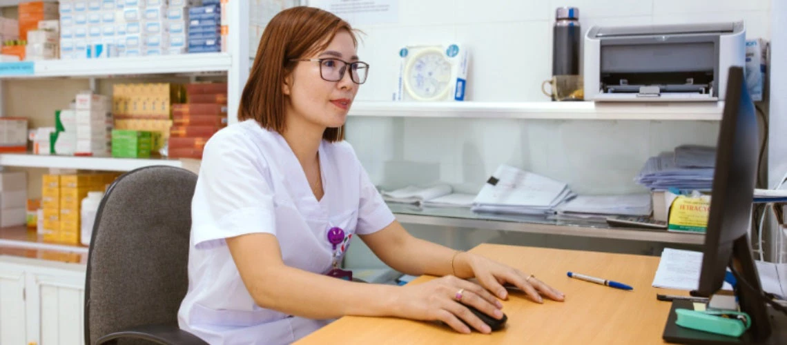 A nurse in front of a computer