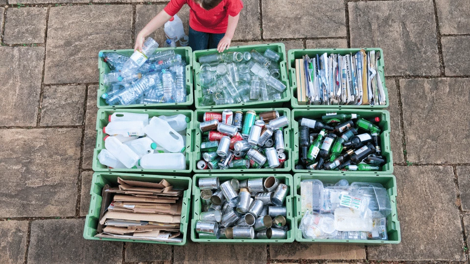 Man sorting recyclables into different baskets.