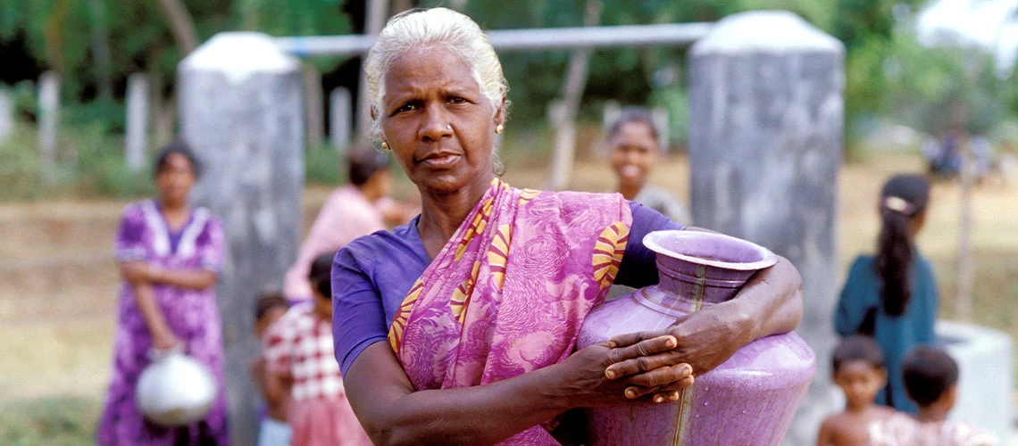 Woman with water container at well. Sri Lanka. Photo © Dominic Sansoni / World Bank